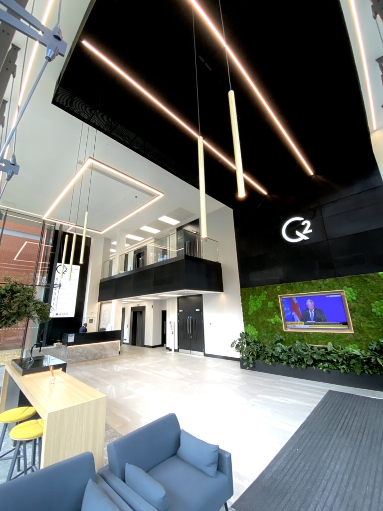 2 Whitehall Quay — double-height reception with bespoke linear LED ceiling installation