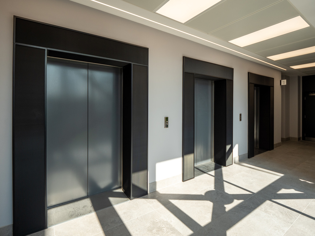 2 Whitehall Quay — lift lobby with architectural linear LED ceiling panels and Deltalight specification