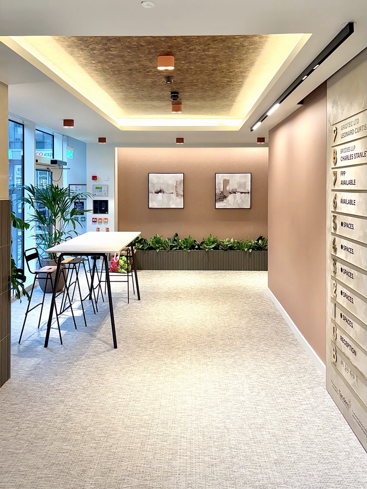 7 Park Row — landlord lounge with coffered feature ceiling, Aqform Vyro 2 surface twin downlights and directory wall