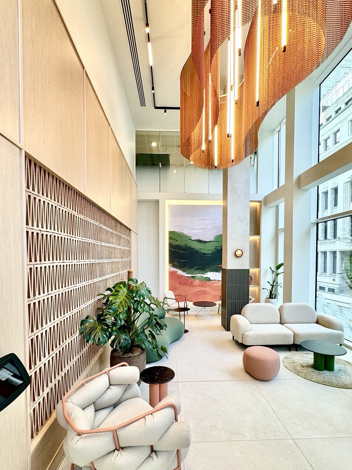 7 Park Row Leeds — double-height reception with sculptural copper feature light and Aqform lighting