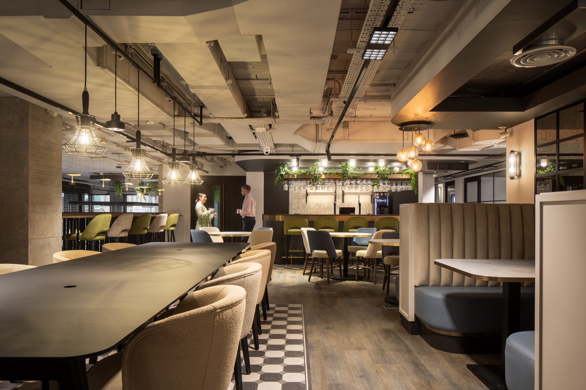 Open-plan office floor with architectural ceiling lighting
