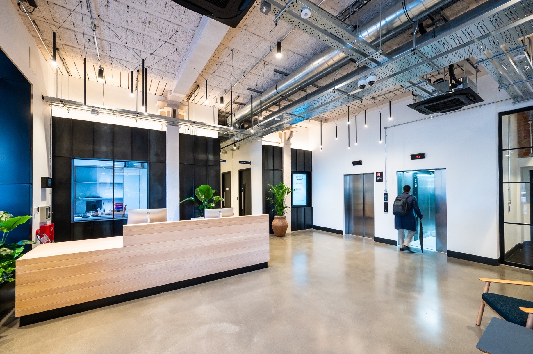 The Centro Buildings — reception with Zava Luce pendants and lift lobby, Lutron Athena scene lighting