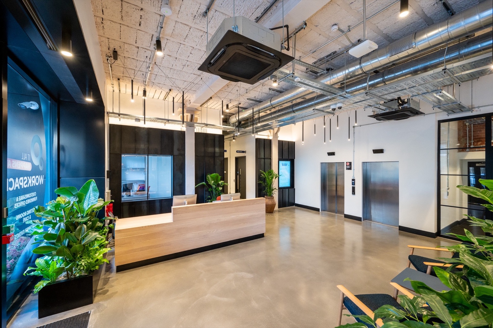 The Centro Buildings — reception with Workspace branding, Zava Luce pendants and Aqform surface-mounted lighting