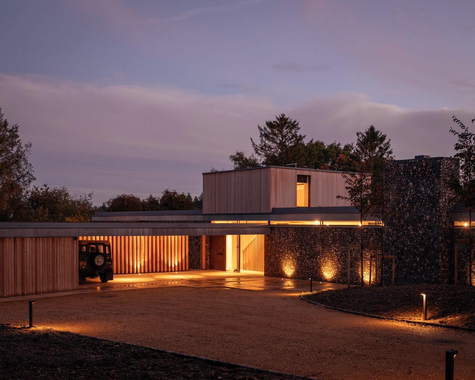 Clayworth — arrival courtyard at dusk, Aqform bollard lighting