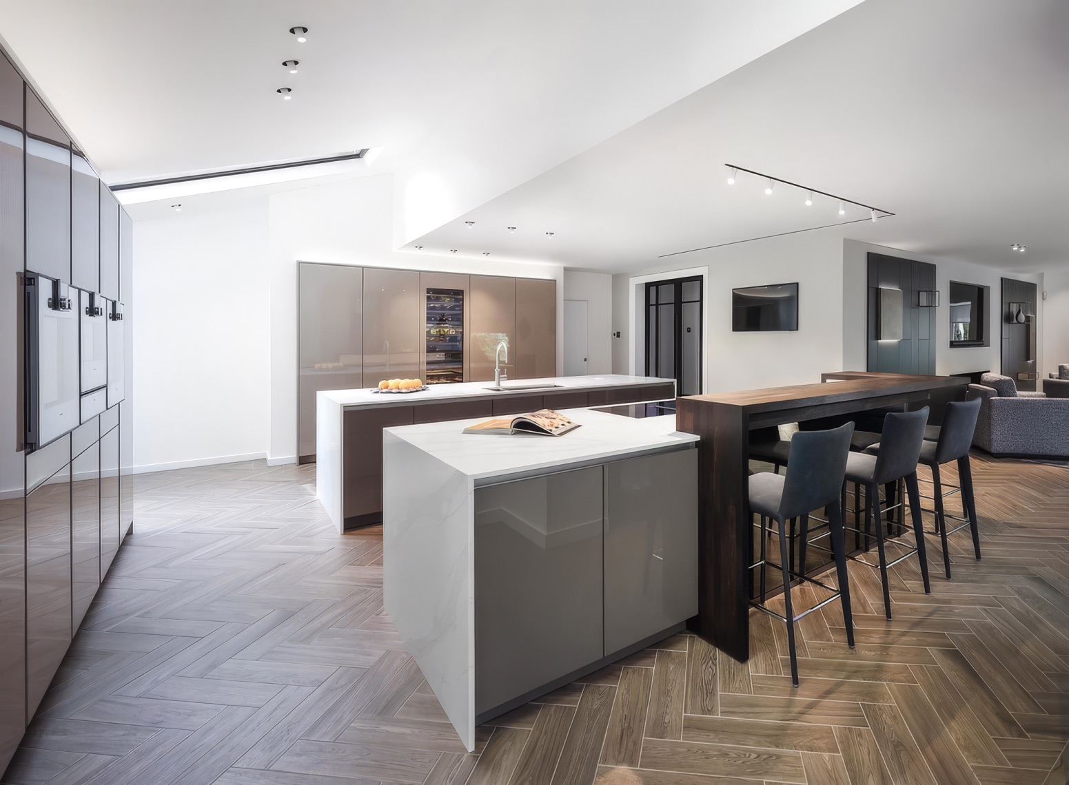 Private residence Bolton — full kitchen extension from living side showing Splitline track and LED cove above cabinetry