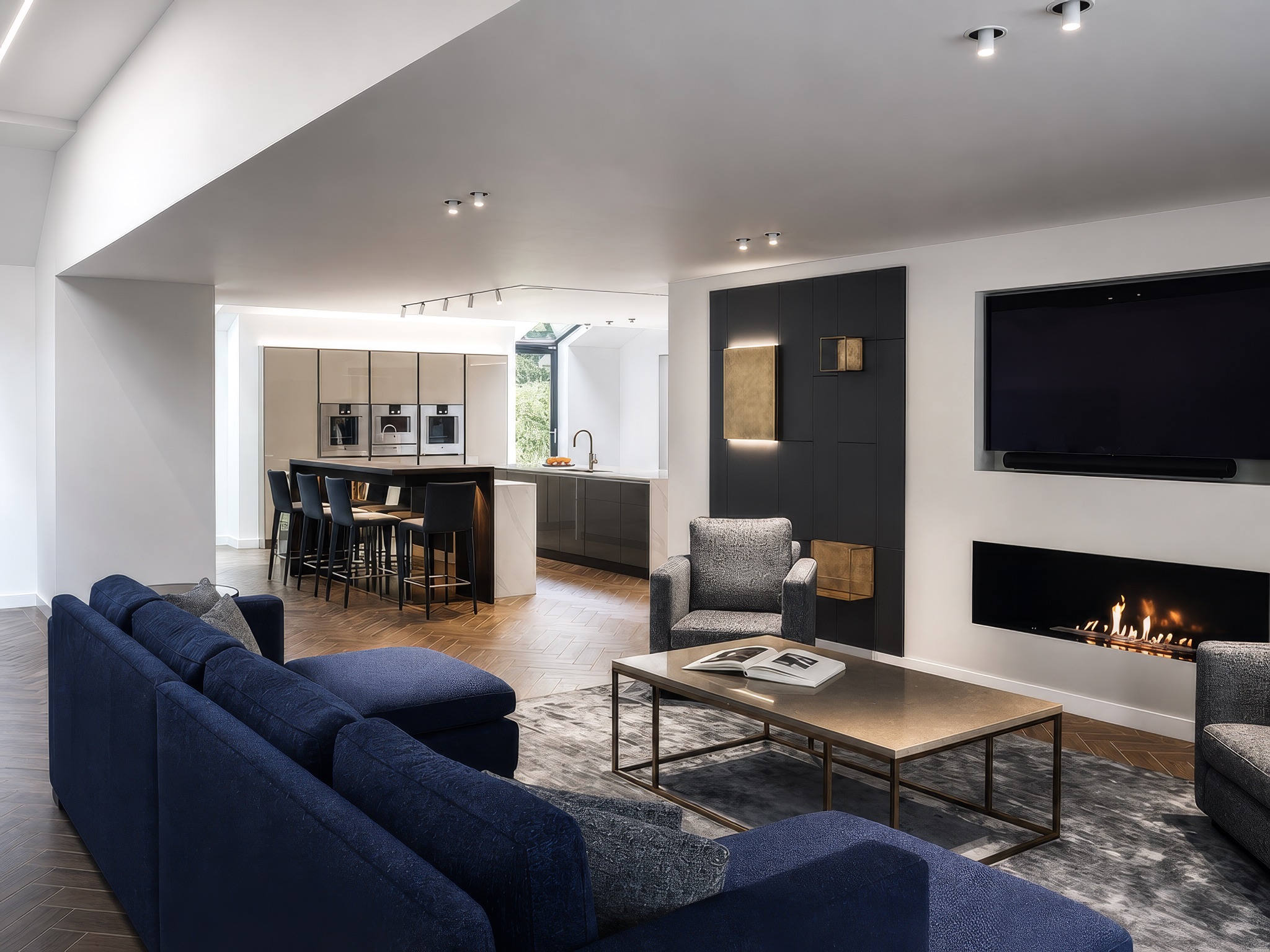 Private residence Bolton — open-plan kitchen and living area showing Deltalight Splitline track and lit media wall niche