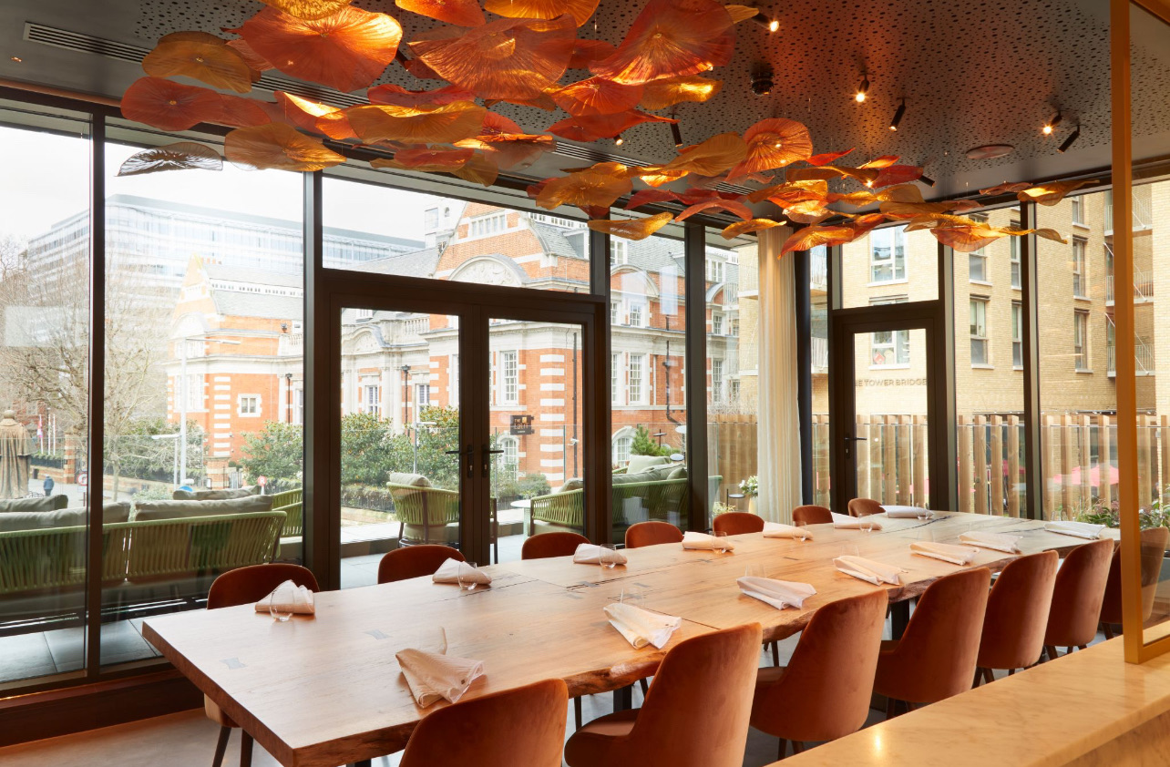 Restaurant Story — dining room with full-width glazing and Aqform Putt Mini ambient lighting