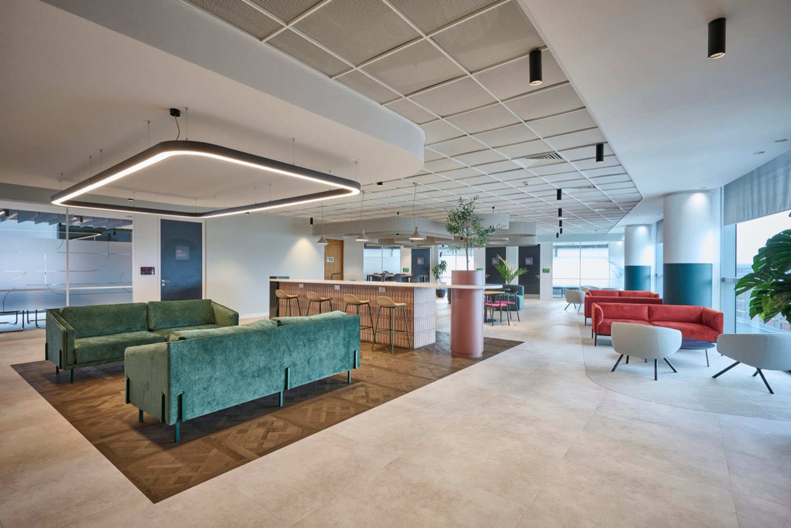 Breakout area with the Serpentine linear ring, kitchen island pendants and lounge seating