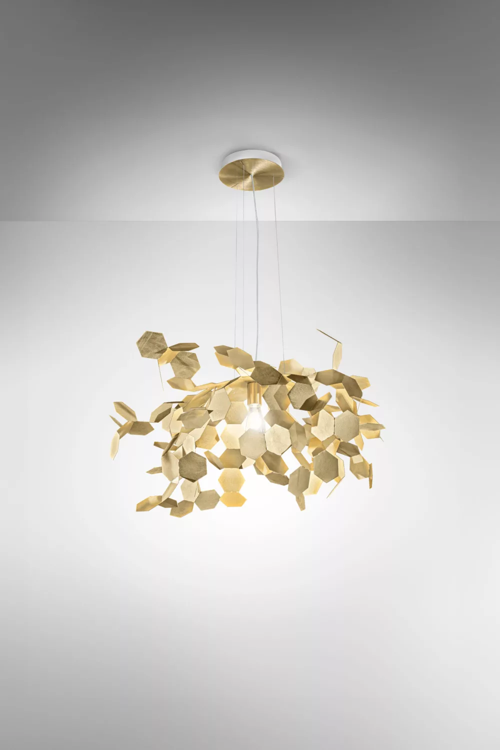 Sculptural brass pendant made of layered hexagonal leaves