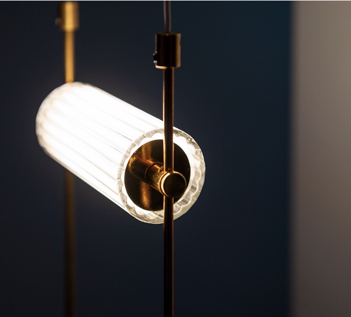 Close-up of a fluted glass cylinder pendant with brass fittings