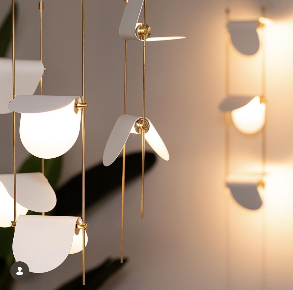 White painted-steel petal lights on slender brass rods